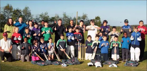  ??  ?? Gorey Cricket Club members at Courtown Hibs grounds with equipment donated by singer songwriter Ed Sheeran, pictured with their club chairman Al Fitzgerald (centre back).