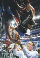  ?? Charlie Riedel, The Associated Press ?? Kansas coach Bill Self signs autographs after practice Wednesday in Kansas City, Mo. The Jayhawks play Purdue in the NCAA Sweet 16 on Thursday.