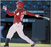  ?? NWA Democrat-Gazette/ANDY SHUPE ?? Arkansas center fielder Dominic Fletcher follows through on a sacrifice fly to score Casey Martin in the Razorbacks’ 11-1 victory Wednesday over Western Illinois at Baum-Walker Stadium. More photos are available at arkansason­line.com/galleries.