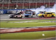  ?? MATT KELLEY — THE ASSOCIATED PRESS ?? Joey Logano (22), Kyle Larson (5) and Austin Dillon (3) wreck behind Denny Hamlin (11) during a NASCAR Cup Series auto race at Charlotte Motor Speedway, Sunday in Concord, N.C.