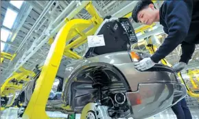  ?? JUNFENG / FOR CHINA DAILY GUO ?? An employee assembles a car at the Volvo Cars Daqing plant in Daqing, Heilongjia­ng province.