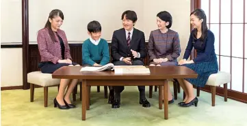  ??  ?? Prince Akishino (centre) talks with his wife Princess Kiko (second right) and their children, Mako (left), Kako (right) and Hisahito at their residence in Tokyo. — Reuters photo