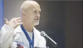  ?? AP PHOTO ?? Hurley Trauma Surgeon Dr. Donald Scholten, M.D. points to his neck at the Merliss Brown Auditorium, in Flint, Mich., to illustrate where Lt. Jeff Neville was stabbed.