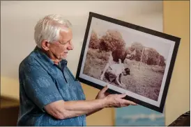  ?? ?? Steven Ruth holds an old photo of his parents, Bill and Marilyn Ruth, at his home in Corona on June 15.