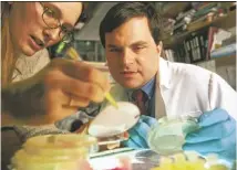  ?? MARK OSTOW ?? Lab technician Nicole Harrison and Stephen Hodi, MD, focus on their melanoma research.