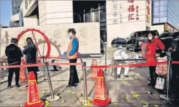  ?? ?? People queue up for a swab test for Covid-19 at a collection site in Beijing on Friday.