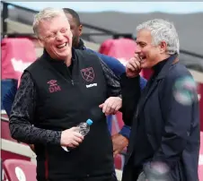  ?? — AFP photo ?? West Ham United manager David Moyes (left) and his Tottenham Hotspur counterpar­t Jose Mourinho share a joke ahead the English Premier League kick off at The London Stadium.