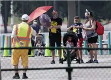  ??  ?? COMING PREPARED: Guests wearing masks enter the Magic Kingdom during the first day of reopening at Walt Disney World on July 11 in Lake Buena Vista, Fla.