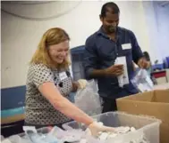  ?? MELISSA RENWICK/TORONTO STAR ?? Volunteer Amanda Lee works with Not Just Tourists director Avi D’Souza to sort medical equipment at Emmanuel Howard Park United Church in Toronto.