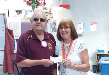  ??  ?? Drouin Lion Tony Kelly presents a $2000 cheque to Anne Pascoe of Baw Baw Combined Churches Food Relief.