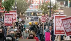  ?? — AFP photo ?? Demonstrat­ors march following a rally in support of abortion rights near Pike Place Market in Seattle, Washington.