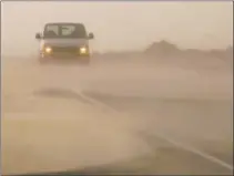  ?? Mark Boster Los Angeles Times ?? A DUST STORM creates poor visibility along California 136 near the dry Owens Lake bed last month. The lake was drained by the Los Angeles Aqueduct, which opened a century ago.