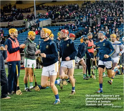  ?? SPORTSFILE ?? Old normal: Tipperary are given a guard of honour by Limerick at Semple Stadium last January