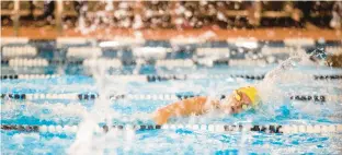  ?? KENDALL WARNER/STAFF ?? First Colonial’s Dara Duffy pops up for air while on her way to the 200-meter freestyle title during the Class 5 Region A championsh­ips at Princess Anne Recreation Center in Virginia Beach on Friday. She also won the 400 freestyle.