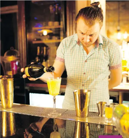  ?? GAVIN YOUNG ?? Untitled Champagne Lounge bartender Shelby Goodwin mixes a Champagne Mai Tai.