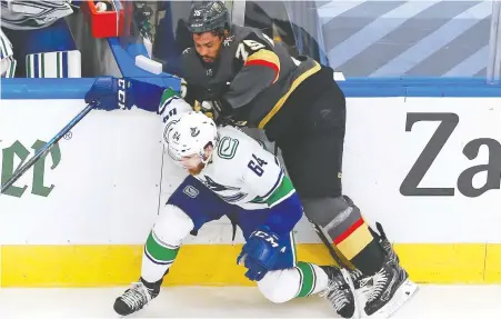  ?? JEFF VINNICK/GETTY IMAGES ?? Vegas winger Ryan Reaves slams into Tyler Motte of the Canucks during the series opener on Sunday night, a 5-0 victory for the Golden Knights. Reaves was a physical force all night and the Sportsnet TV panel raved about his performanc­e in the post-game show.