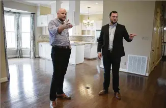  ?? DEBORAH CANNON / AMERICAN-STATESMAN ?? Perry Horton (left) talks Tuesday with his real estate agent, Sean Mooney, inside the home Horton has under contract in the Austin area. “It’s an uber-hot market,” said a local broker.