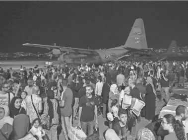  ?? KHALIL MAZRAAWI/AFP VIA GETTY IMAGES ?? People evacuated from Sudan arrive at a military airport in Amman, Jordan, on Monday. A stream of European and Mideast military aircraft flew into Sudan all day Sunday, through the night and into Monday to ferry people out.