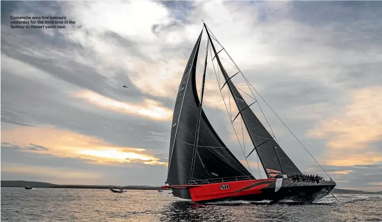  ?? AP ?? Comanche wins line honours yesterday for the third time in the Sydney to Hobart yacht race.