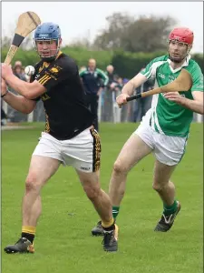  ??  ?? Adamstown full-back Colm Boland about to clear as Seán Kehoe (Crossabeg-Ballymurn) moves in.