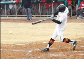  ?? Westside Eagle Observer/MIKE ECKELS ?? Mason Dagley gets a piece of the ball (center, left), sending it towards left field during the March 7 Gravette-Grove baseball game in Gravette.