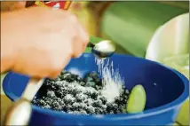  ??  ?? Hopkins mixes ingredient­s for a pie at her home in Los Angeles.