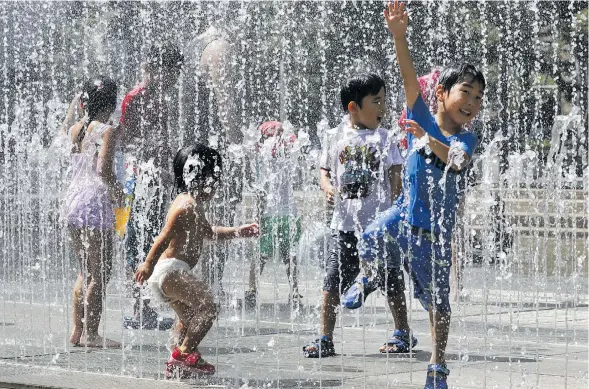  ??  ?? Children play in the water jets at a park near Nerima in Tokyo as temperatur­e rose up to 39.6 degrees Celcious in Japan’s latest heatwave that has killed at least 80 people and is now being classified as a natural disaster.