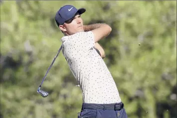  ?? Matthew Stockman / Getty ?? Russell Henley hits off the 13th tee during the third round of the CJ Cup on Saturday. He parred the hole after starting the back nine with three straight birdies to rally.