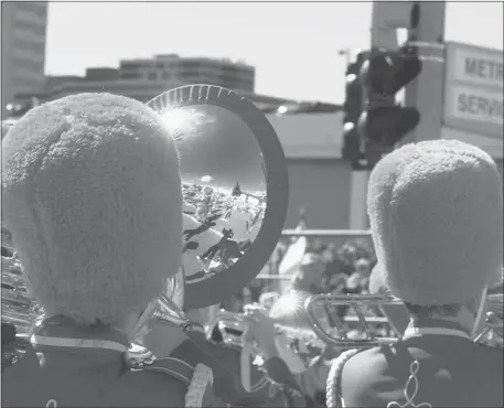  ?? Calgary Herald Archive ?? Members of the Red Deer Royals marching band are reflected in the horn of a brass player during the 1996 Calgary Stampede Parade.