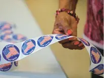  ?? STAFF ?? Patsy Bowman prepares stickers for voters at the Courthouse
Way Community Center in Newport News on March 3, 2020, during the state’s Democratic presidenti­al primary election.