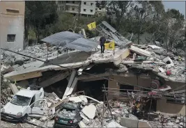  ?? CMOHAMMED ZAATARI— THE ASSOCIATED PRESS ?? A man stands on a house that was destroyed by an Israeli airstrike in Hanine village, south Lebanon, on Thursday. Hezbollah militants and Israeli forces have been exchanging fire since a day after the Israel-hamas war began on Oct. 7.