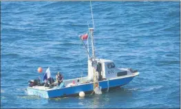  ?? PHOTOS BY MICHELLE BLACKWELL — ADVOCATE-NEWS ?? Father and son team Patrick and Grant Downee, of Fort Bragg, anchor their boat near Noyo Harbor, to begin diving for invasive purple urchins.