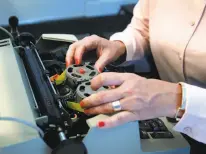  ?? Paul Chinn / The Chronicle ?? Lisa Larkworthy of the city’s Minard Capital changes the ribbon on an IBM Selectric Personal typewriter.