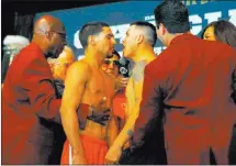  ?? Heidi Fang ?? Headliners Danny Garcia, left, and Brandon Rios, share a heated exchange at the weigh-in Friday at the Mandalay Bay.
Las Vegas Review-journal @Heidifang