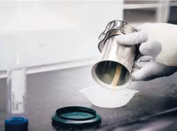  ?? ERIN SCHAFF/THE NEW YORK TIMES ?? A lab technician pours out ground samples of bone for DNA identifica­tion last month at Dover Air Force Base in Dover, Delaware. A tactic used to solve murders could help track down family members of fallen soldiers.