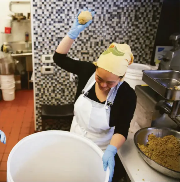  ?? Samantha Laurey / The Chronicle ?? i rice, beans and morel mushrooms into a barrel. After eight months, the mixture will emerge as miso. The couple are known for using local, unexpected ingredient­s.