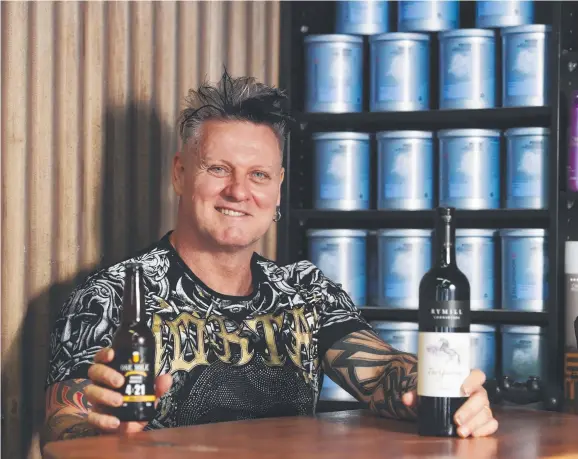  ??  ?? Hair Dude owner Gary Strachan has renovated his shop and started to build a bar out the back despite Darwin's unstable economic situation