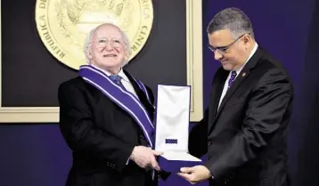  ??  ?? HIGHEST HONOUR: President Higgins with president of El Salvador Don Maurico Funes