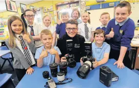  ??  ?? Snap happy Chris McIntyre joins pupils on the other side of the camera