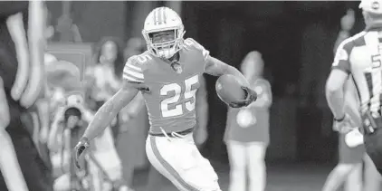  ?? LYNNE SLADKY/AP ?? Dolphins cornerback Xavien Howard scores a touchdown after intercepti­ng a Patriots pass on Jan. 9 in Miami Gardens.