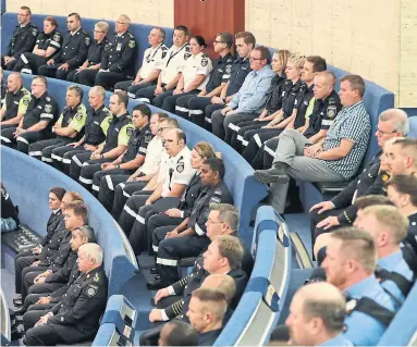  ?? RANDY RISLING/TORONTO STAR ?? About 50 uniformed men and women gathered at city hall, where they were applauded by councillor­s.