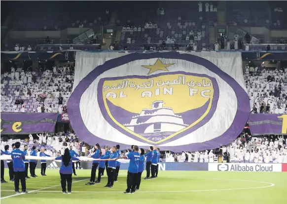  ?? Chris Whiteoak / The National ?? Supporters display the club’s crest ahead of Al Ain’s match against Wellington in the Fifa Club World Cup at the Hazza bin Zayed Stadium