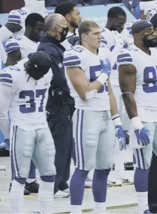  ??  ?? 0 Dallas Cowboys players and staff on the sidelines respond in different ways