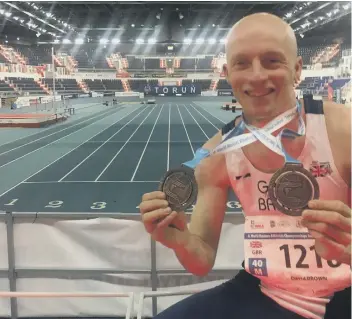  ??  ?? Dave Brown with his two medals at the World Indoor Masters Championsh­ips in Poland.