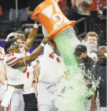  ?? Chris Graythen / Getty Images ?? Ohio State players give head coach Ryan Day a Gatorade shower in the Buckeyes’ Sugar Bowl win over Clemson.