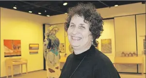  ?? MILLICENT MCKAY/JOURNAL PIONEER ?? Paula Kenny, the director of Eptek Art and Culture Centre, stands in the middle of the Eptek Art and Culture Centre gallery. Kenny will retire after the opening of the summer exhibit “Art Begets Art: Hooked Mats and the Art that Inspired Them”.