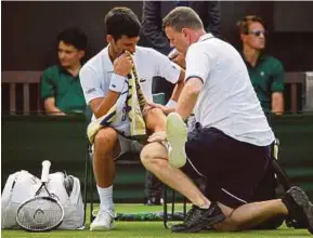  ?? REUTERS PIC ?? Novak Djokovic receives medical attention in the Wimbledon Championsh­ips second round match against Horacio Zeballos in London yesterday.