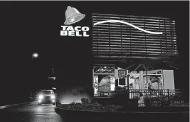  ?? [PHOTO BY LUKE SHARRETT, BLOOMBERG] ?? A customer sits at the takeout window of a Taco Bell restaurant at in Shelbyvill­e, Kentucky.