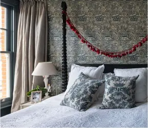  ??  ?? Below: Wallpaper in William Morris’ Wandle design makes a stunning feature wall behind the bed. The other walls are painted in Farrow & Ball’s striking Inchyra Blue shade