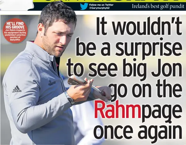  ??  ?? HE’LL FIND HIS GROOVE Jon Rahm inspects his equipment during yesterday’s practice session at Ballyliffi­n